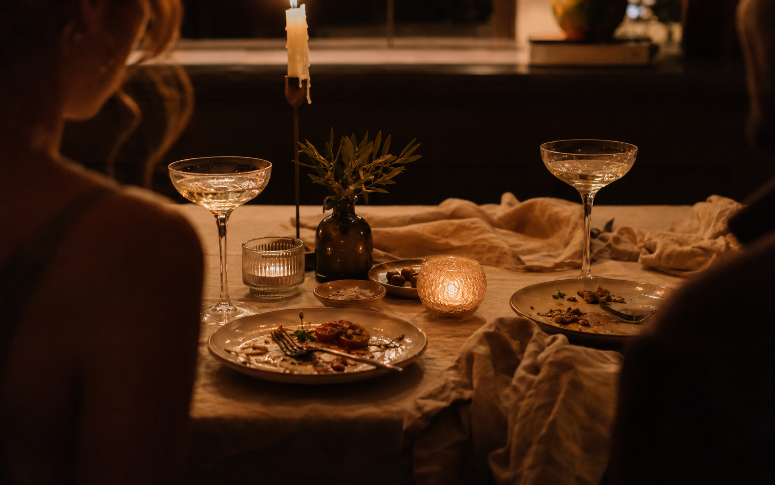 An intimate candlelit dinner table